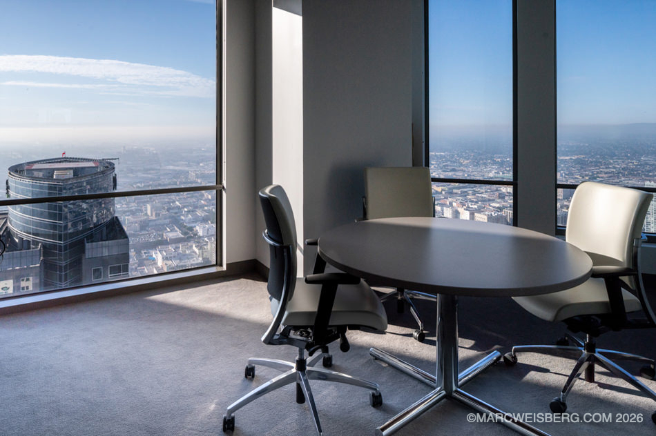 Office suite conference table with floor to ceiling windows overlooking Los Angeles