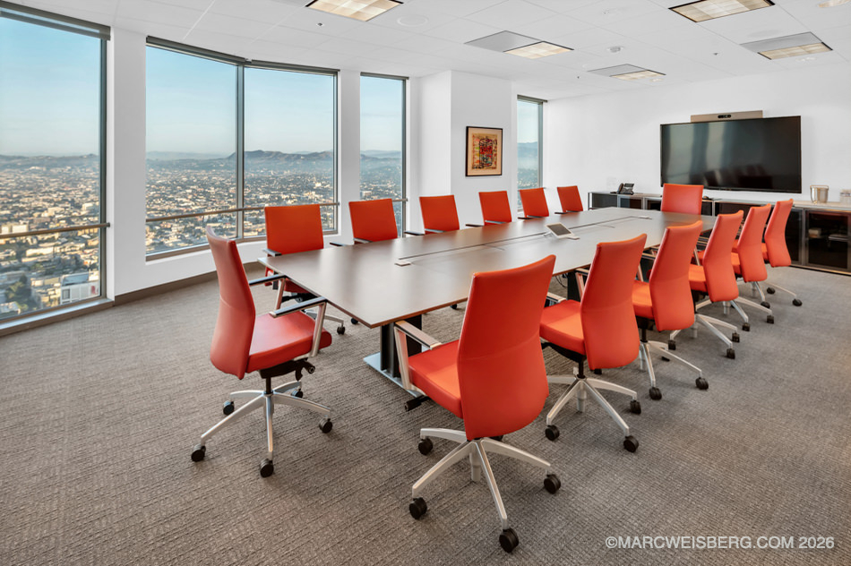 Law firm conference room with orange chairs and city views in Century City