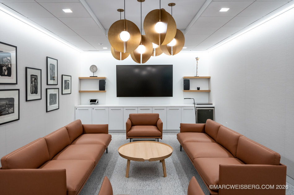 Private listening room with leather sofas and pendant lights at Manatt headquarters in Century City