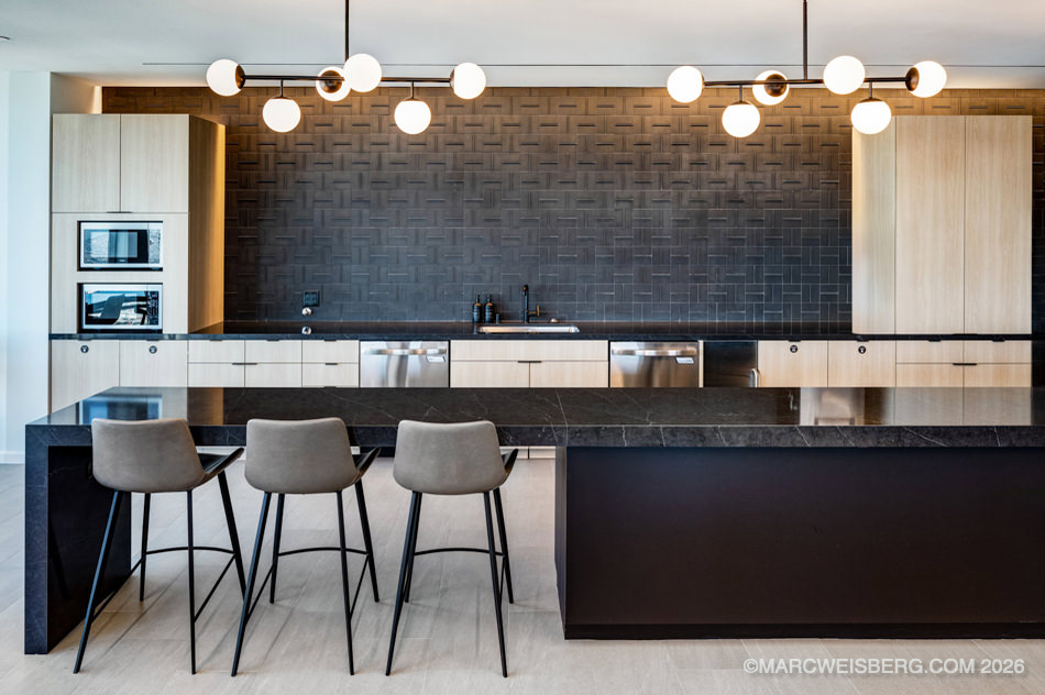 Office community kitchen with bar stools and pendant lighting