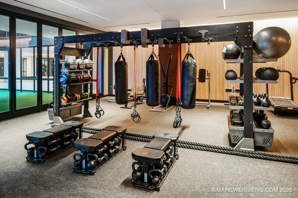 Employee fitness area with punching bags, kettlebells and training rack in a tech office